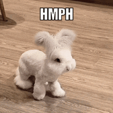 a white stuffed animal with the word hmph written above it