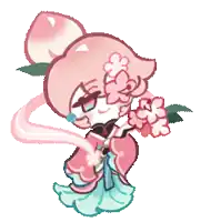 a peach cookie with a bun and flowers on her head is holding flowers .