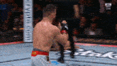 a man in a boxing ring with a sign that says ufc