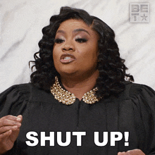 a woman in a judge 's gown says " shut up "
