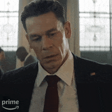 a man in a suit and tie with the word prime on the bottom