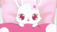 a white rabbit with a flower on its head is laying on a pink pillow