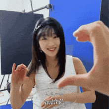 a woman in a white tank top is smiling while holding a glass plaque with the word bride written on it