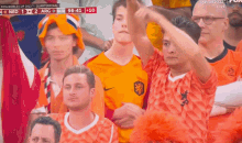 a crowd of people watching a soccer game with the score at 96 41 10