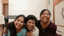 three women are posing for a picture together and laughing