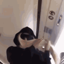 a person wearing a hooded jacket is making a heart shape with their hands on an airplane .
