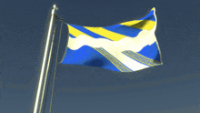 a blue and yellow flag is flying in the wind against a blue sky