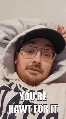 a man wearing glasses and a hat with the words you 're hawt for it above him