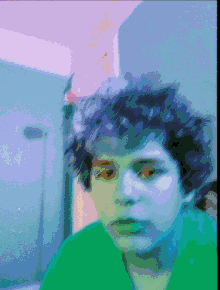 a pixelated image of a person 's face with a green shirt on