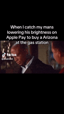 a man in a suit is talking to another man in a gas station while using an apple pay app .