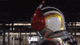 a close up of a person wearing a helmet with a red nose .