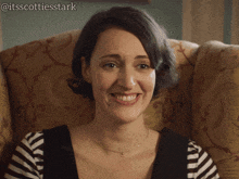 a woman is smiling in a chair with the hashtag @itsscottiesstark