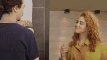 a man and a woman are standing next to each other and talking