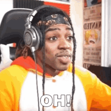 a man wearing headphones and a headband with the word oh written on it