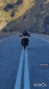 a man is riding a motorcycle on a road with the words pcfr ub inshot below him