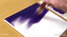 a person is painting a canvas with purple paint and the words made in animatica on the bottom