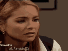 a close up of a woman 's face with the hashtag lialmeida05 on the bottom right