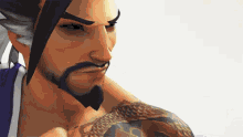 a man with a beard and tattoo on his arm