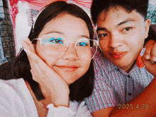 a man and a woman are posing for a picture and the date of the photo is 2025.4.26