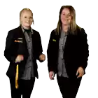 two women wearing black jackets with the letter bo on the sleeve