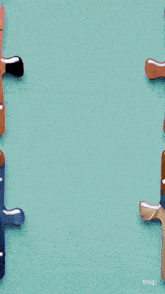 a person is holding a piece of a puzzle with the word tmq on the bottom