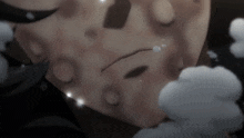 a close up of a person 's face with clouds in the background .