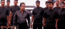 a group of men are standing in front of a white car with the caption im_alhindi