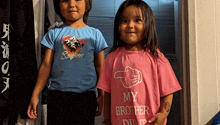 a little girl in a pink shirt that says my brother did it