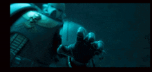 a person 's hand is reaching out towards the camera in a dark room