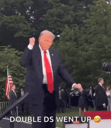 a man in a suit and tie is dancing in front of a white house .