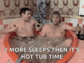 two men are sitting in a hot tub holding bottles of alcohol .