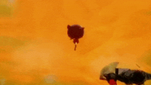 a man is laying on the ground in front of a fireball .