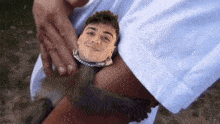 a man is holding a monkey with a picture of a man on it