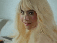 a close up of a woman wearing a blonde wig