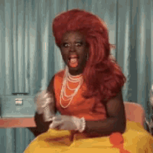 bob the drag queen sips drink tea orangedress