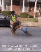 a woman is pushing a child on the ground while a car is parked in the background .