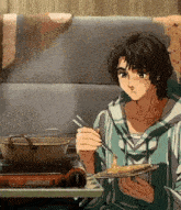 a man is eating noodles with chopsticks in front of a stove