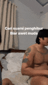 a shirtless man is sitting on a bed with the words cari suami penghibur biar awet muda written above him