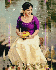 a woman in a purple top and white skirt is sitting on a rock in the water