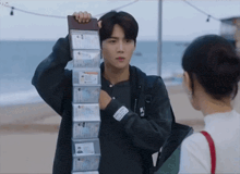 a man is holding a stack of id cards in his hand