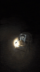 a dark room with a light shining through the window
