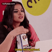 a woman is holding a bag of chips and saying `` what ? dump the boyfriend '' .