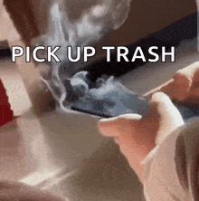 a person is smoking a cigarette with smoke coming out of it and the words pick up trash above them