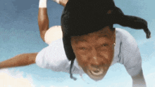 a man wearing a hat is flying in the air