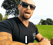 a man wearing sunglasses and a shirt that says gp