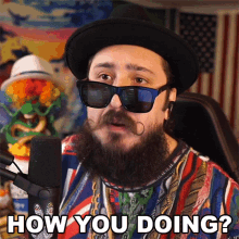 a man with a beard wearing sunglasses and a hat says " how you doing "