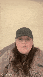 a woman wearing a ny hat and a cameo logo on her shirt