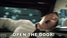a man in a suit and tie is yawning with the words open the door behind him