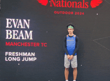 evan beam is standing in front of a nationals outdoor 2024 sign