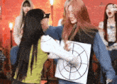 two women are hugging each other while one of them is wearing a target .